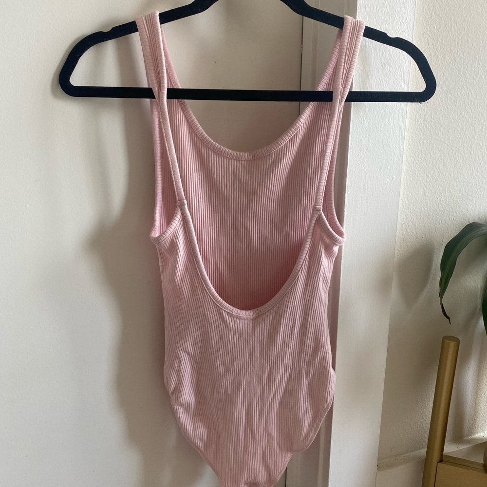 Ribbed baby pink low back body suit from UO